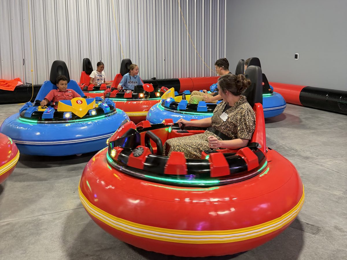 Kids and adults riding bumper cars at Alleyway Entertainment